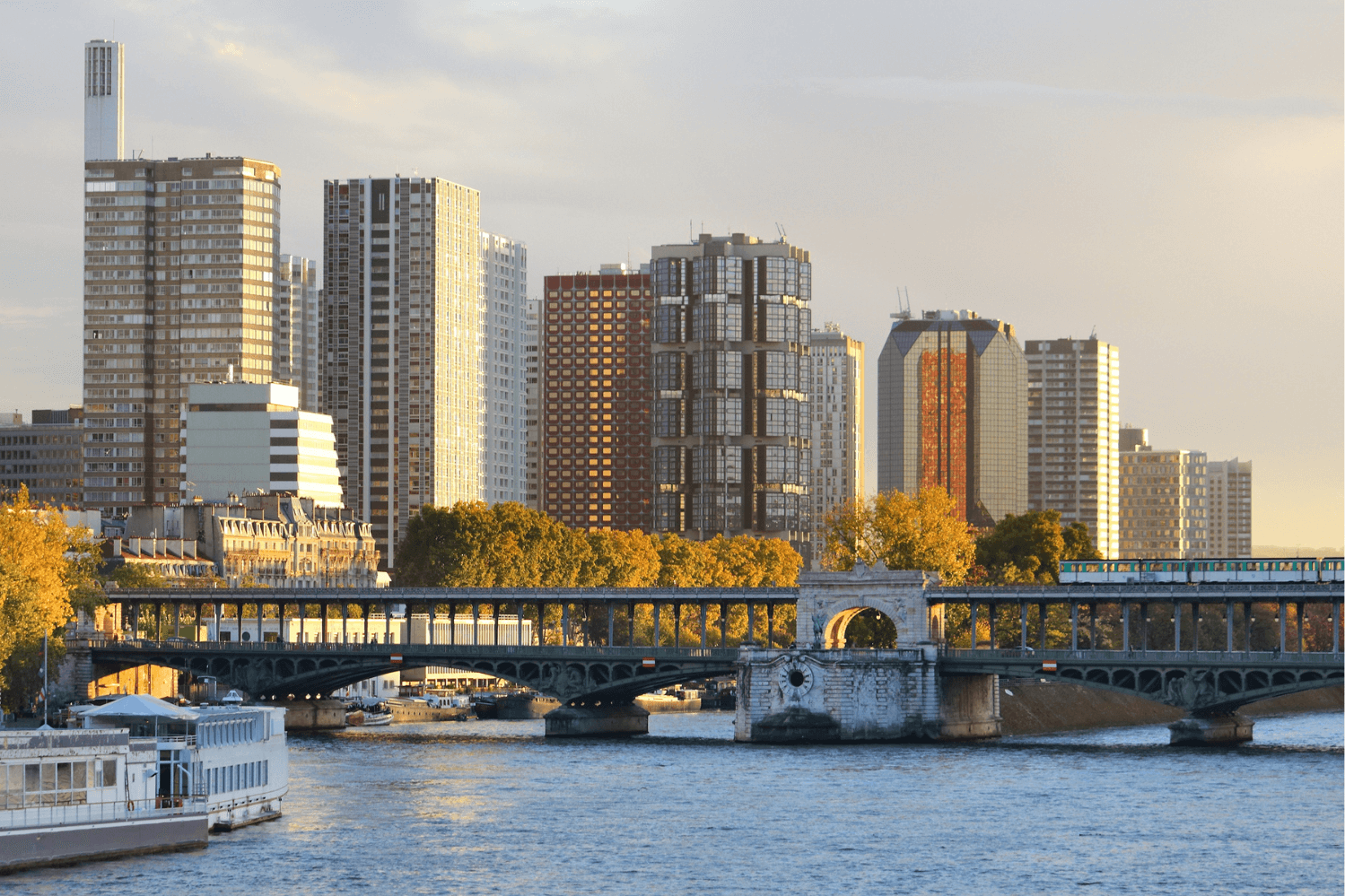 Cityscape of the Grenelle neighborhood in the 15th arrondissement of Paris, showcasing modern high-rise buildings along the Seine River. 