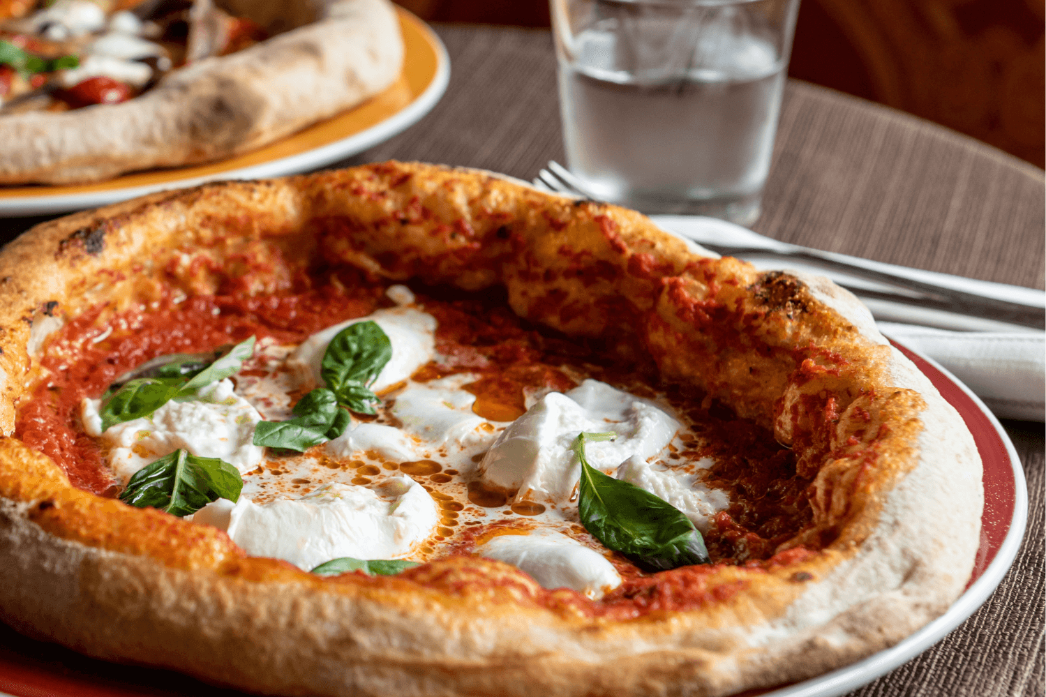 Neapolitan-style pizzas with with burrata cheese and basil